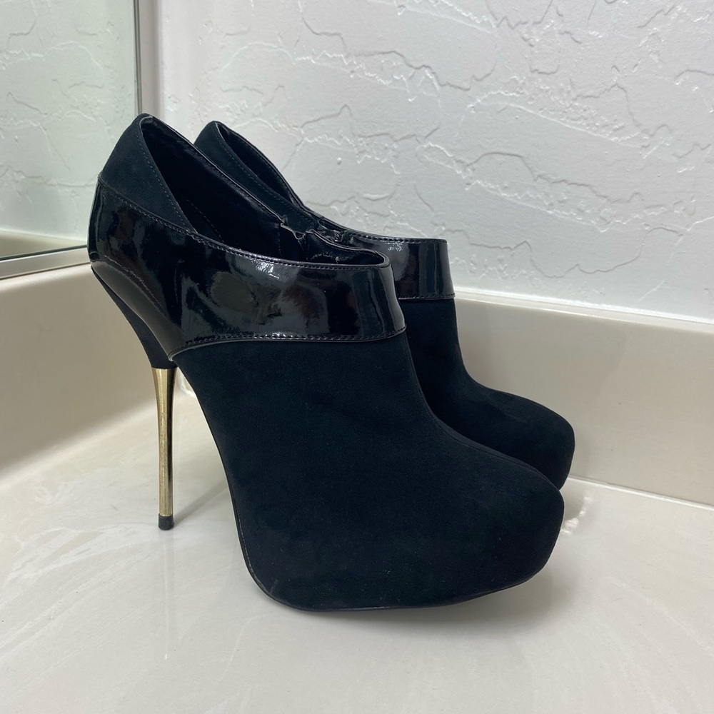 Black ankle booties with gold heel